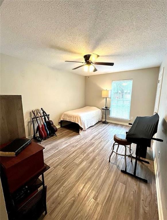 8653 Rosalene St E, Grand Bay, AL 36541 - bedroom featuring wood finished floors, a textured ceiling, and ceiling fan