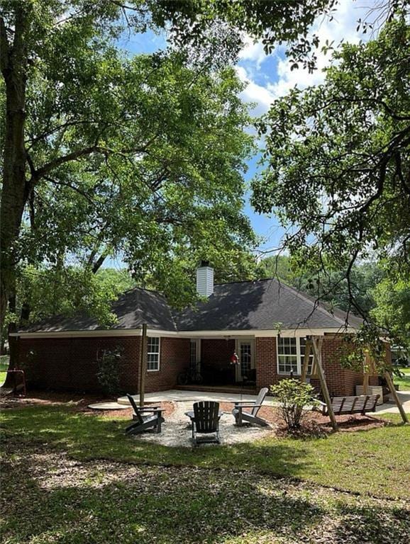 8653 Rosalene St E, Grand Bay, AL 36541 - back of property featuring a patio area, brick siding, a chimney, and a yard