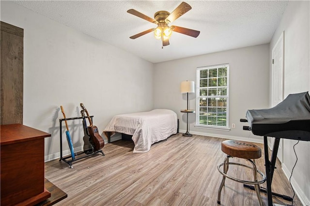 8653 Rosalene St E, Grand Bay, AL 36541 - bedroom featuring wood finished floors, a textured ceiling, baseboards, and a ceiling fan