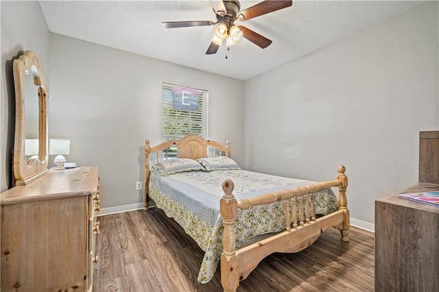 8653 Rosalene St E, Grand Bay, AL 36541 - bedroom featuring wood finished floors, a textured ceiling, baseboards, and a ceiling fan