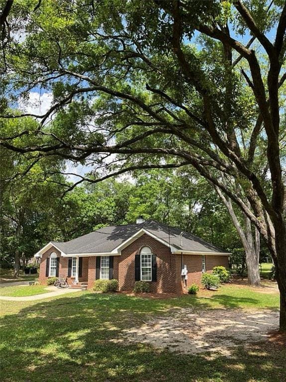 8653 Rosalene St E, Grand Bay, AL 36541 - single story home featuring brick siding, a front yard, and view of scattered trees