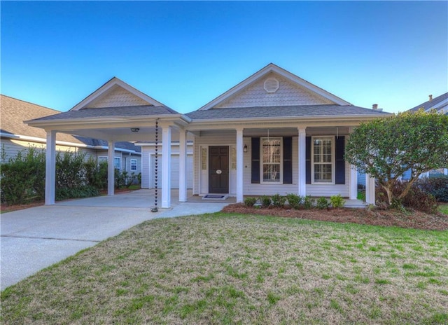 view of front of house with covered porch, a front yard, and a carport