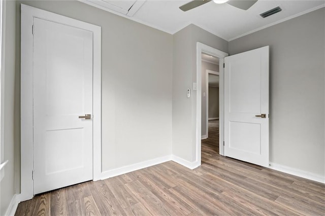 unfurnished bedroom with crown molding, ceiling fan, and light hardwood / wood-style flooring