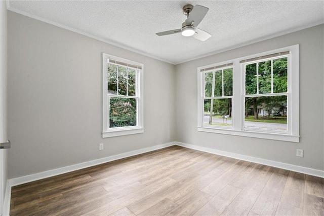 empty room featuring ceiling fan, hardwood / wood-style floors, and a textured ceiling