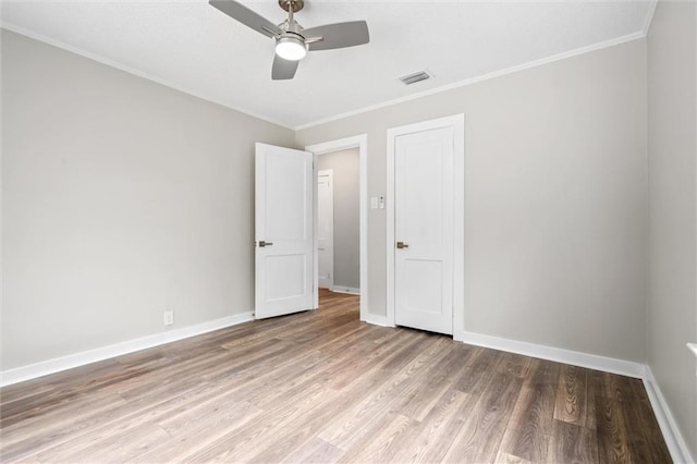 unfurnished bedroom featuring ceiling fan, ornamental molding, and light hardwood / wood-style floors