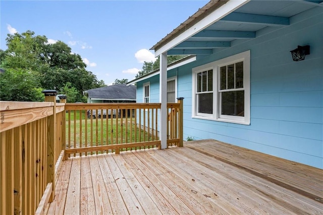 wooden terrace featuring a yard