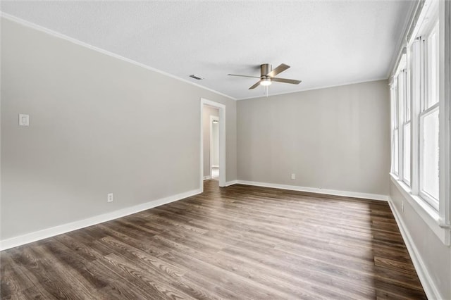 unfurnished room featuring ornamental molding, dark hardwood / wood-style floors, a textured ceiling, and ceiling fan