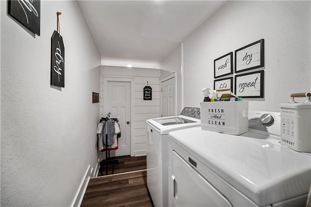 laundry room with dark hardwood / wood-style floors and washing machine and clothes dryer