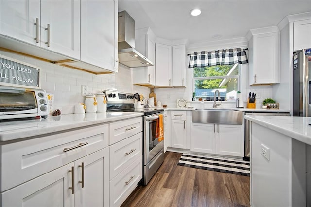 kitchen featuring stainless steel electric stove, white cabinetry, light stone countertops, wall chimney exhaust hood, and sink