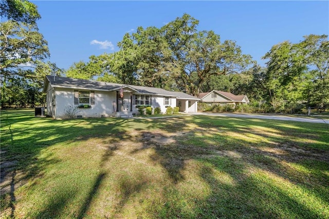 single story home with central air condition unit and a front lawn