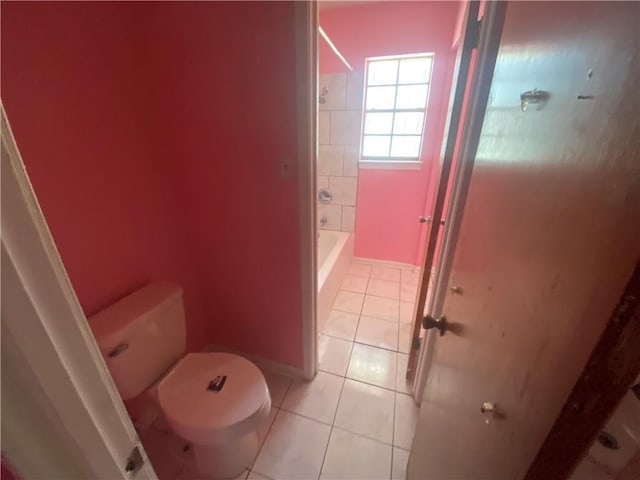 bathroom featuring baseboards, toilet, and tile patterned flooring