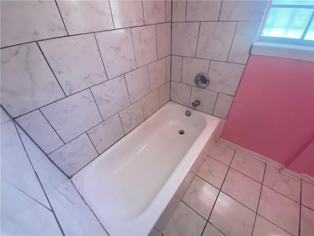 full bathroom with baseboards and tile patterned floors