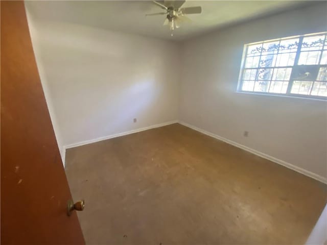 unfurnished room featuring baseboards and ceiling fan