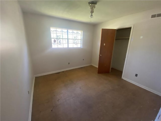 unfurnished bedroom with baseboards, visible vents, a closet, and tile patterned floors
