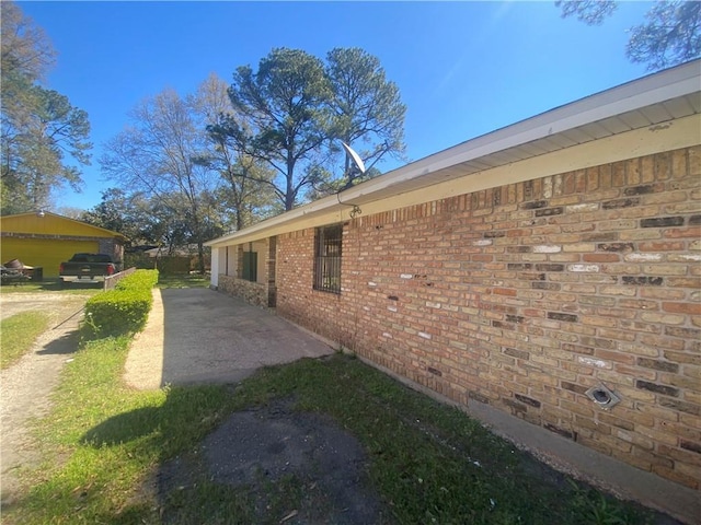view of side of property with brick siding
