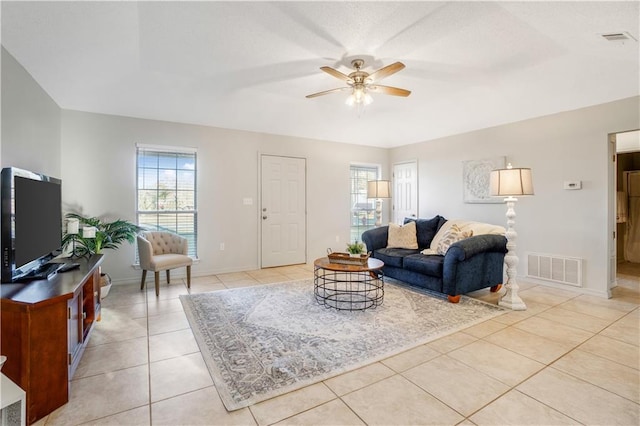 tiled living room with ceiling fan