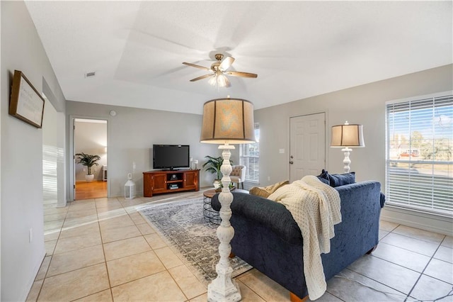 tiled living room with ceiling fan