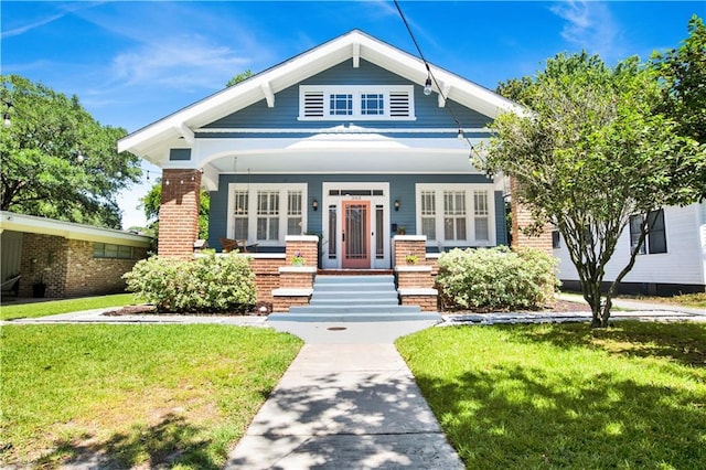 303 Monterey St S, Mobile, AL 36604 - view of front facade with a front yard, brick siding, and a porch