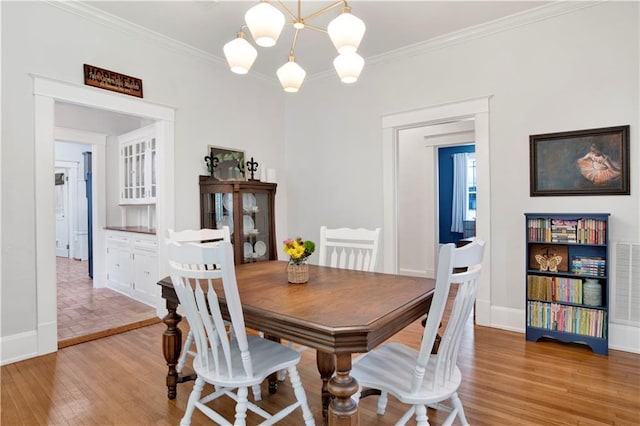 303 Monterey St S, Mobile, AL 36604 - dining room featuring light wood-style floors, baseboards, and ornamental molding