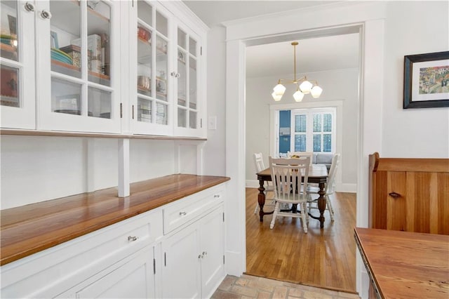 303 Monterey St S, Mobile, AL 36604 - dining space with crown molding, a chandelier, and brick patterned floors