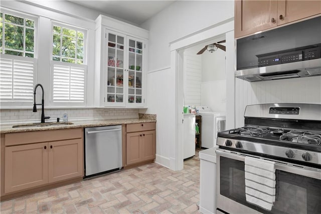 303 Monterey St S, Mobile, AL 36604 - kitchen with appliances with stainless steel finishes, a sink, ceiling fan, brick patterned floors, and independent washer and dryer