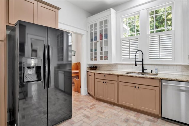 303 Monterey St S, Mobile, AL 36604 - kitchen with black fridge, dishwasher, a sink, brick flooring, and backsplash