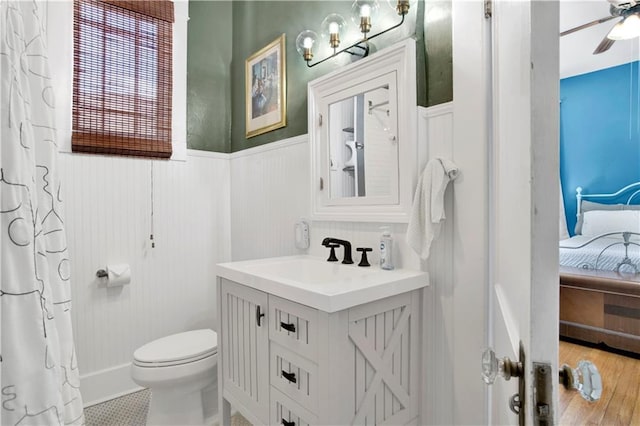 303 Monterey St S, Mobile, AL 36604 - ensuite bathroom featuring vanity, toilet, a wainscoted wall, and ceiling fan