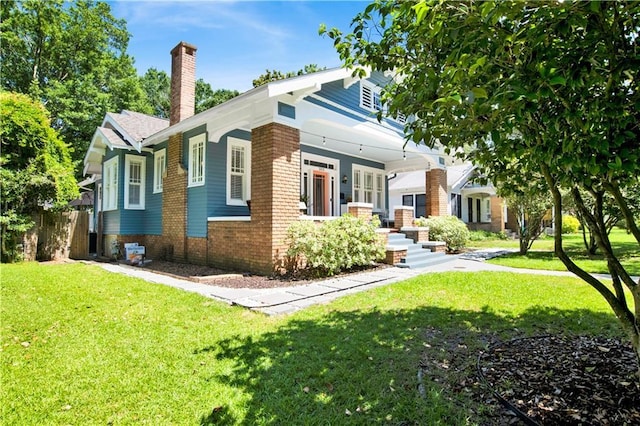 303 Monterey St S, Mobile, AL 36604 - view of side of home with a chimney, covered porch, and brick siding