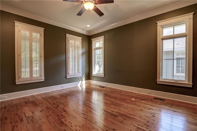 unfurnished room featuring hardwood / wood-style flooring, crown molding, and ceiling fan