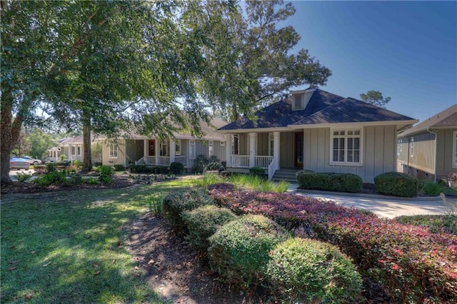 single story home featuring a front lawn and a porch