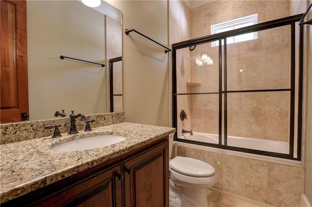 full bathroom with toilet, combined bath / shower with glass door, tile patterned flooring, and vanity