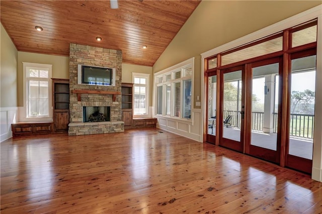 unfurnished living room featuring wood-type flooring, wood ceiling, and plenty of natural light