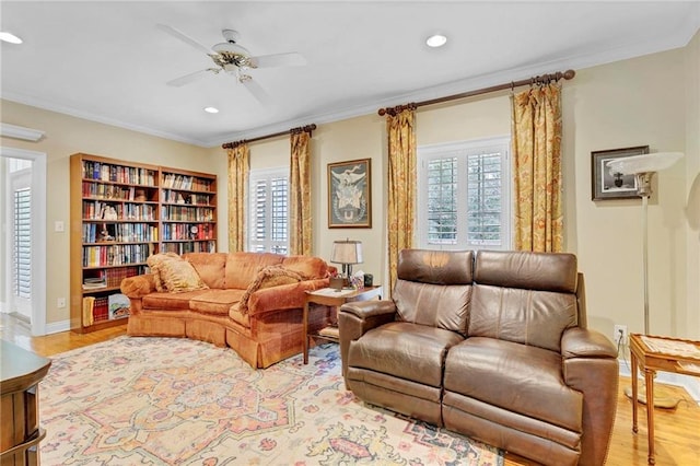 living room featuring ornamental molding, ceiling fan, and light hardwood / wood-style flooring