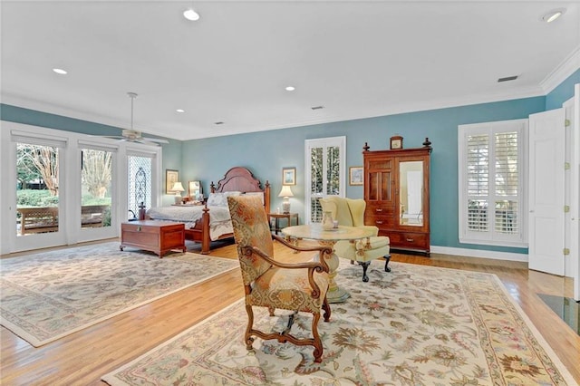 bedroom with light hardwood / wood-style flooring, access to outside, and ornamental molding