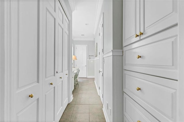 hall featuring crown molding and light tile patterned flooring