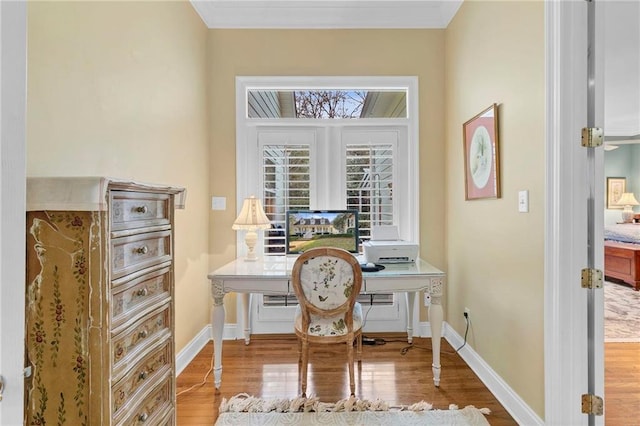 home office featuring ornamental molding and light hardwood / wood-style flooring