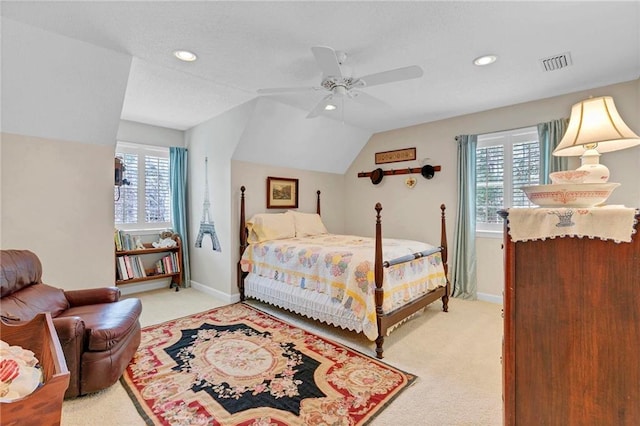 carpeted bedroom featuring ceiling fan, lofted ceiling, and multiple windows