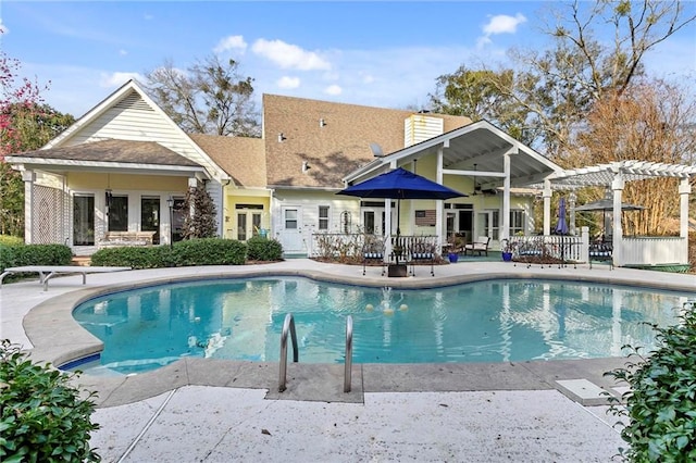 view of swimming pool with a pergola, a patio area, french doors, and ceiling fan