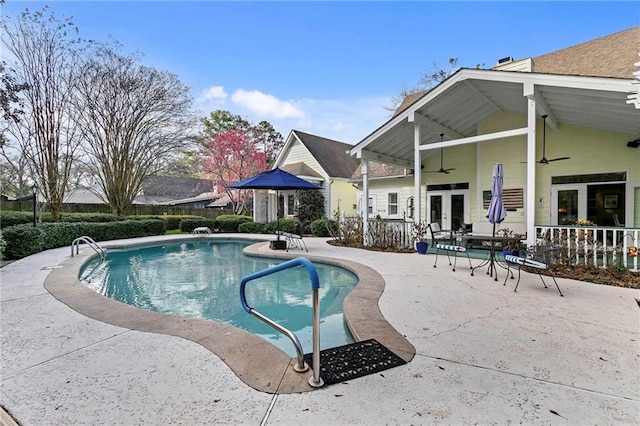 view of swimming pool featuring a patio area, french doors, and ceiling fan