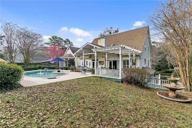 back of property featuring a patio, a lawn, and a pergola