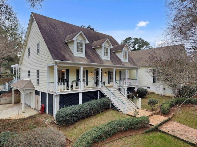 cape cod-style house with a garage and covered porch