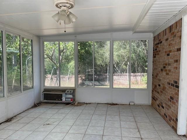 unfurnished sunroom featuring plenty of natural light and ceiling fan