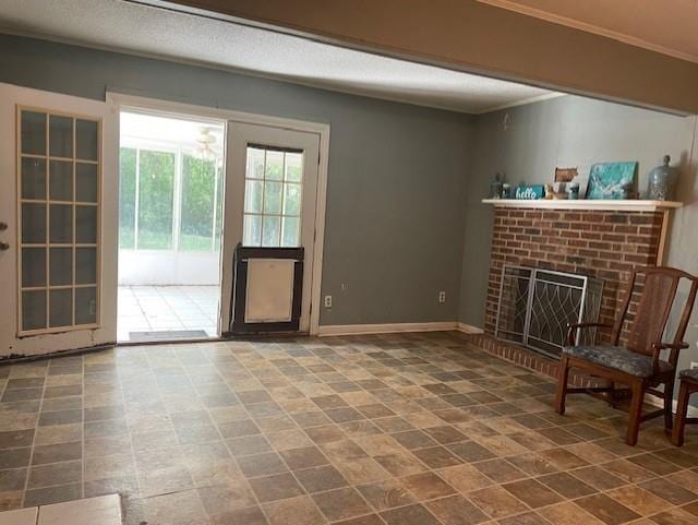 unfurnished room featuring ornamental molding, baseboards, and a fireplace