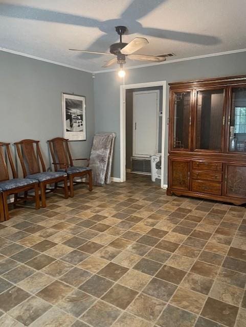 living area with visible vents, crown molding, and a ceiling fan
