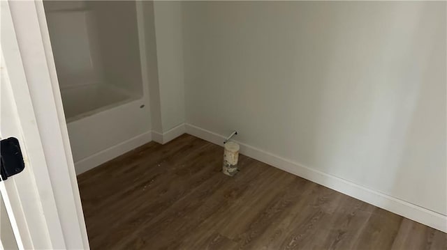 interior space featuring dark wood finished floors and baseboards