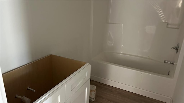 bathroom with vanity, shower / bathtub combination, and wood finished floors