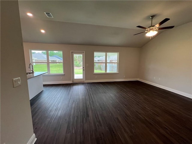 empty room with lofted ceiling, sink, dark hardwood / wood-style floors, and ceiling fan