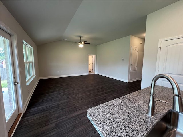 living room featuring ceiling fan, lofted ceiling, sink, and dark hardwood / wood-style flooring