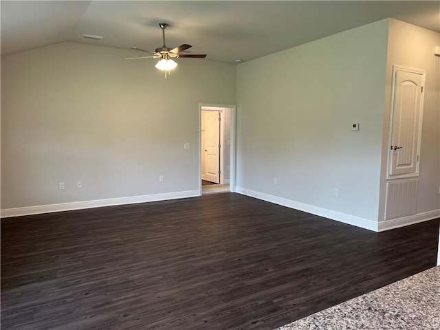 spare room with vaulted ceiling, dark hardwood / wood-style floors, and ceiling fan