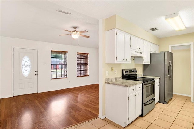 kitchen featuring stainless steel appliances, visible vents, under cabinet range hood, and white cabinetry